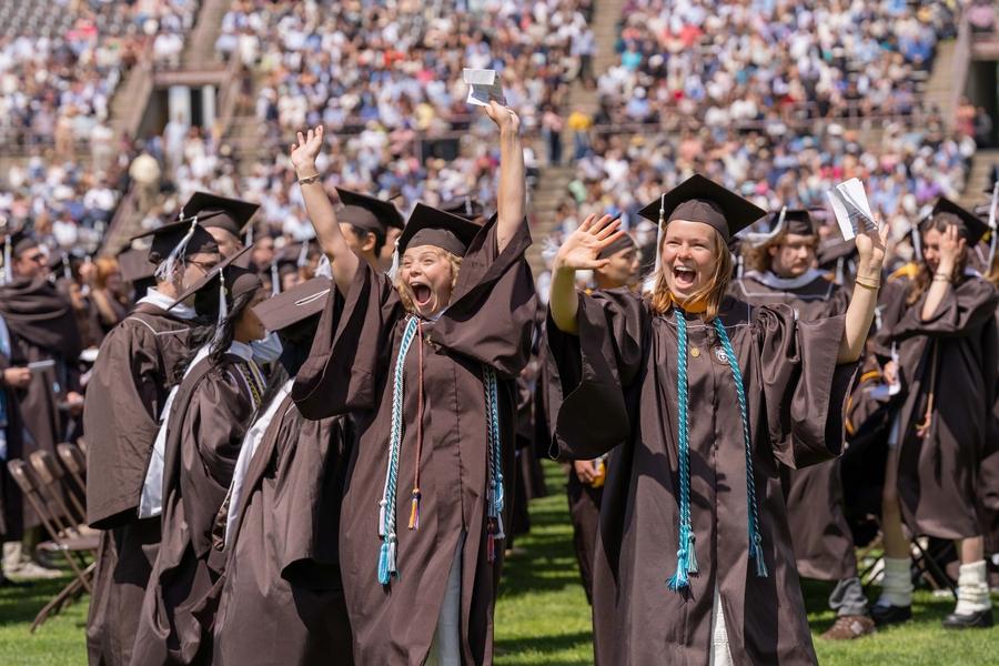 Graduate with her arms in the air