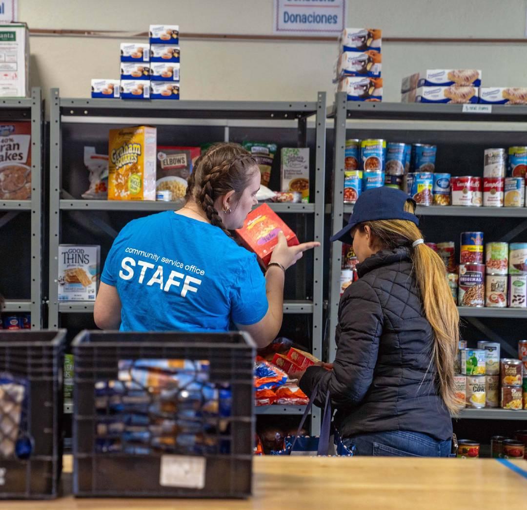 Two volunteers working at a food bank