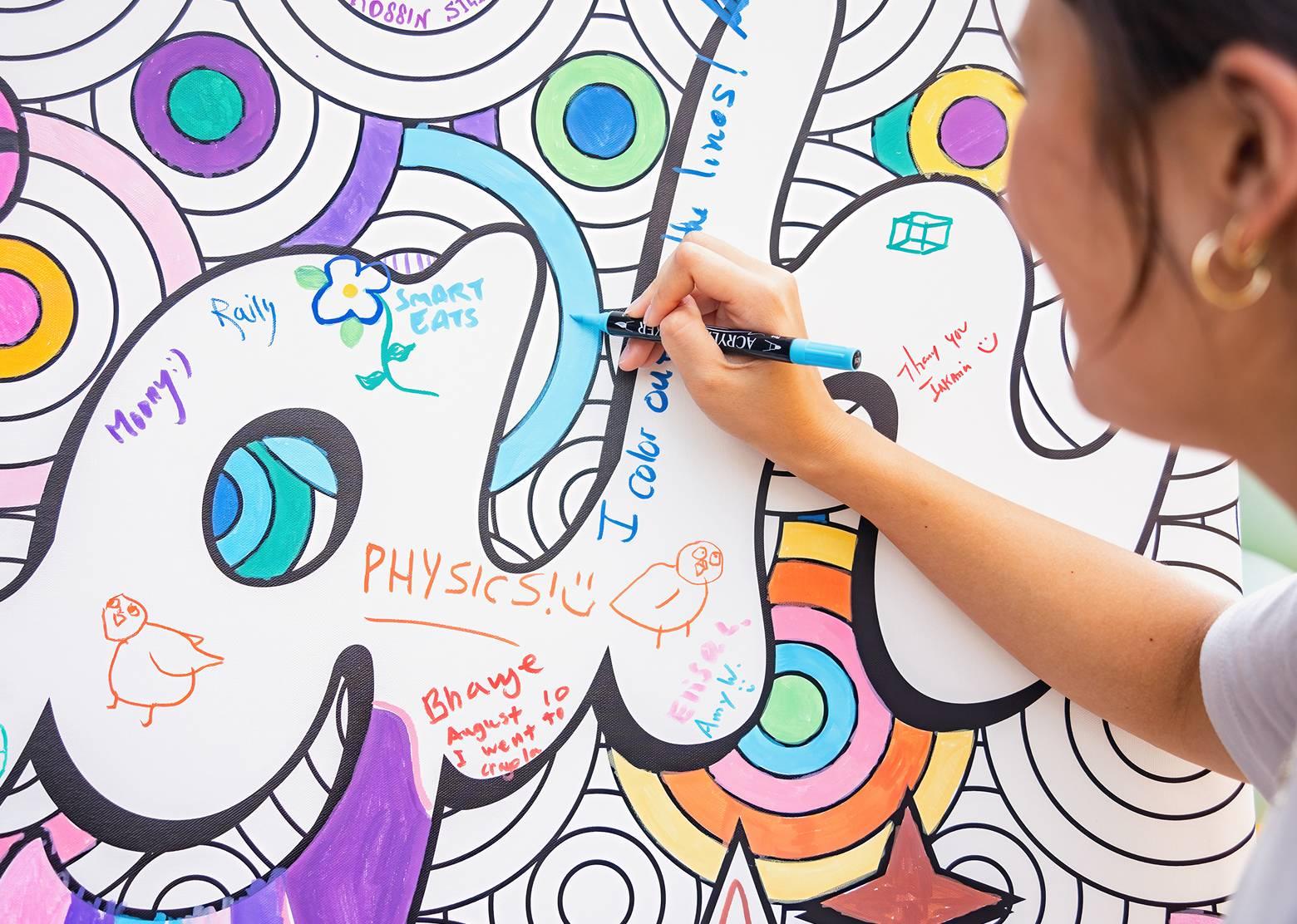 Woman signing a wall at Musikfest