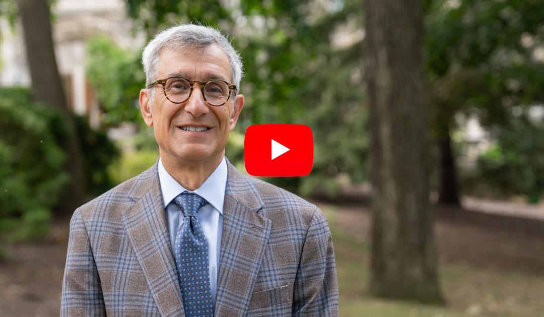 President Helble standing on campus on walking path