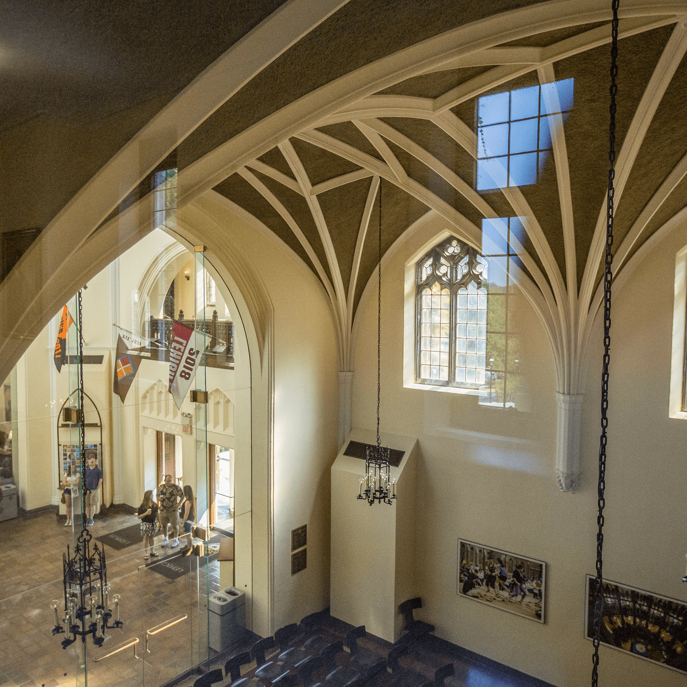 Interior view of Alumni Memorial Building with vaulted ceilings and stained glass windows.