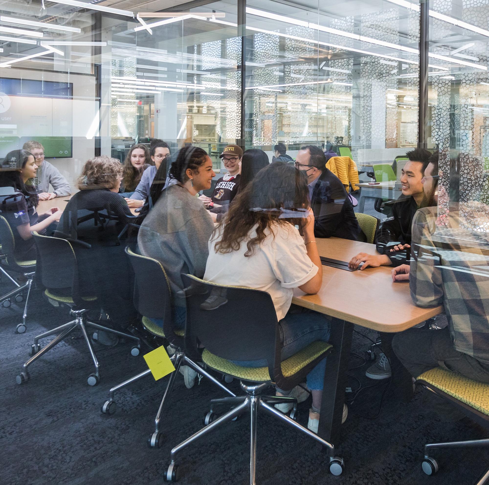 A group of people sitting at a conference table
