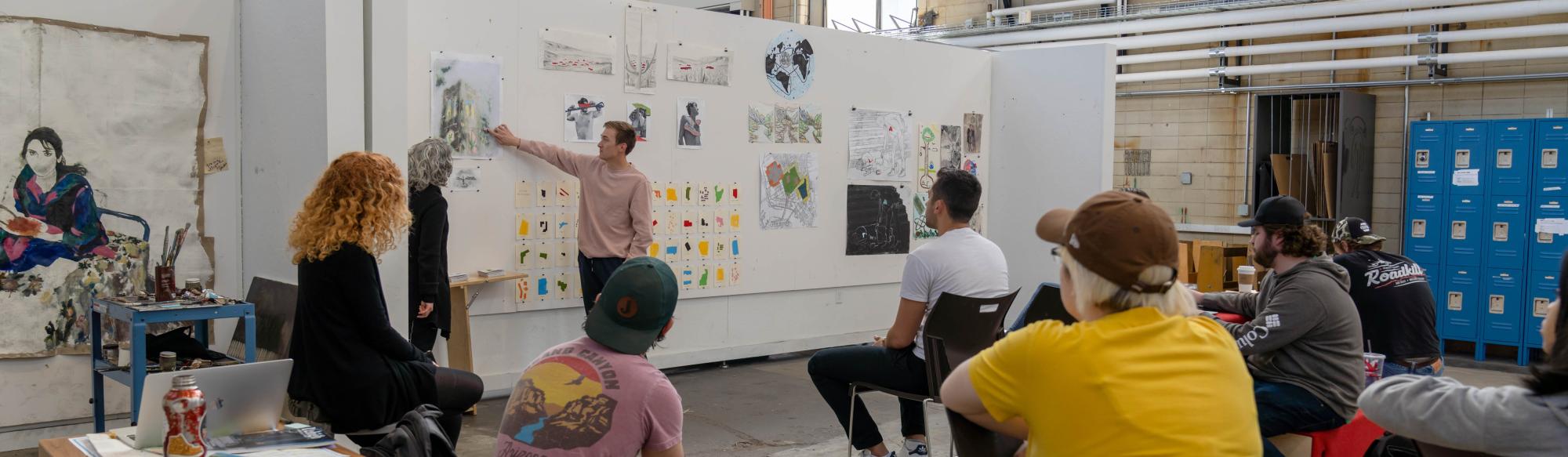 A classroom setting where a professor demonstrates on a white board