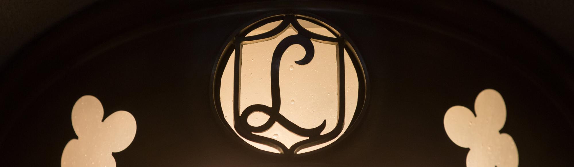 Cutout of the letter 'L' in a cursive font