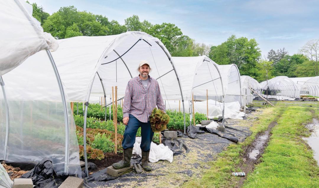 Matt Salvaterra in front of one of the tunnels at his gardens