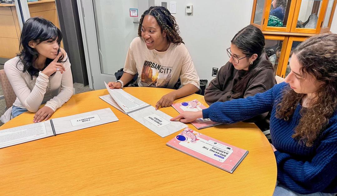 People reading books around a table