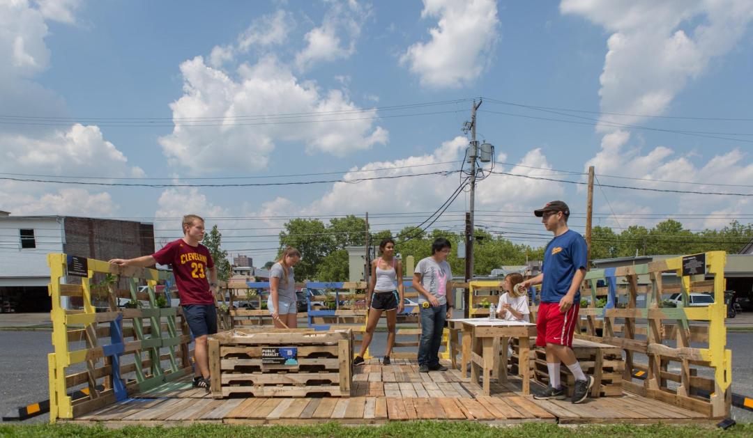 Volunteers painting wooden pallets