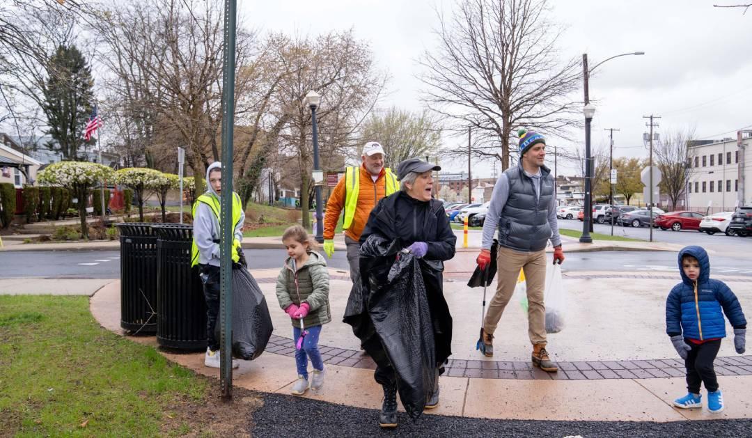 Volunteers in a park with trash bags