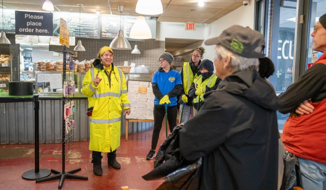 Volunteer speaking to other volunteers in a deli