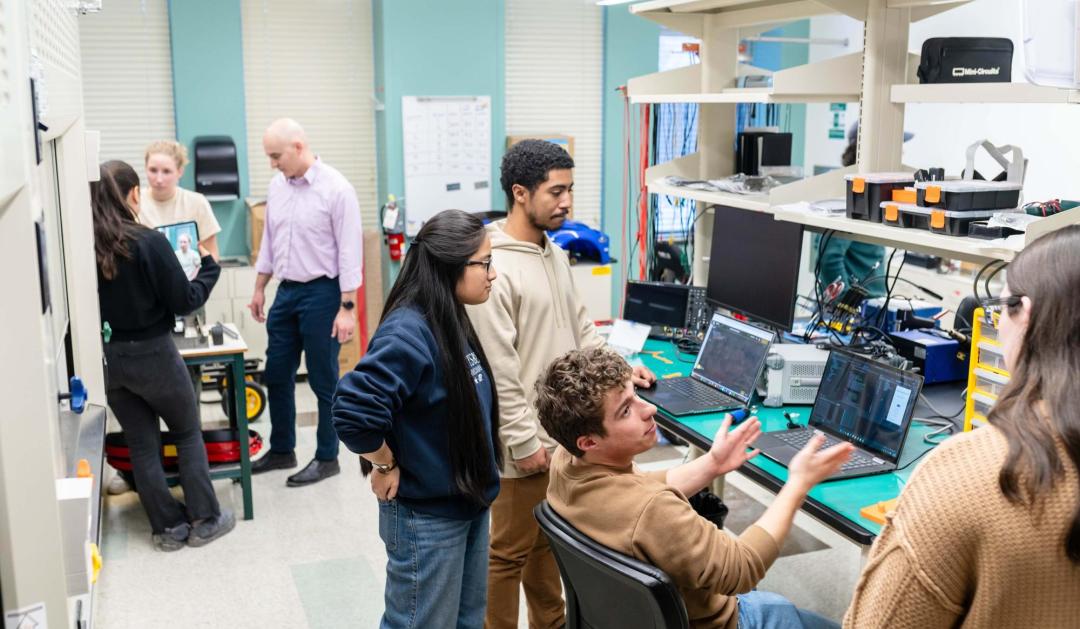 Multiple people working in a computer lab