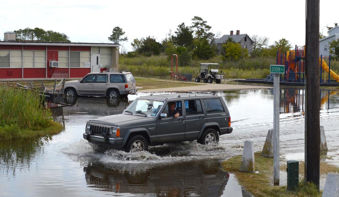 An SUV traversing a flooded area