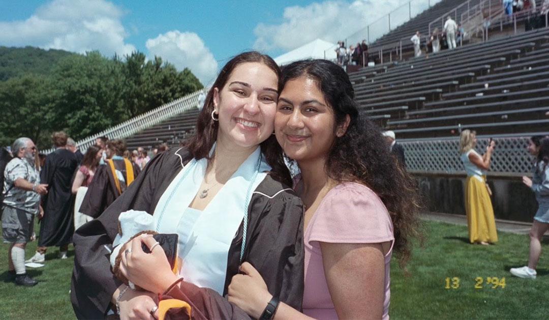 Two people posing for a photo during outdoor commencement
