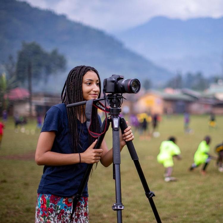 Student with a tripod and camera
