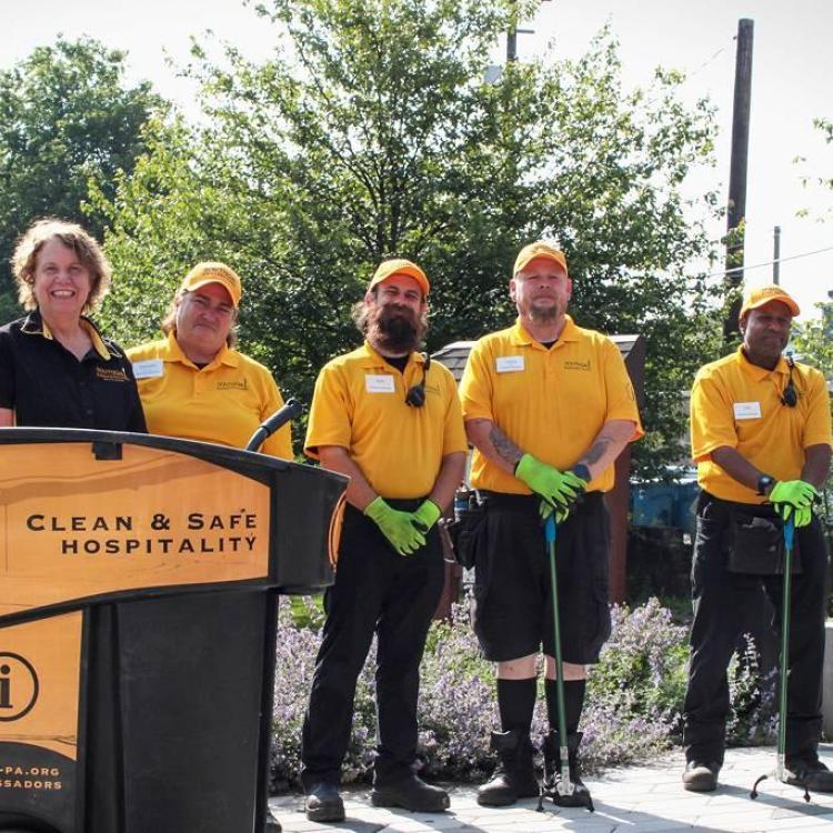 People posing near a podium outdoors