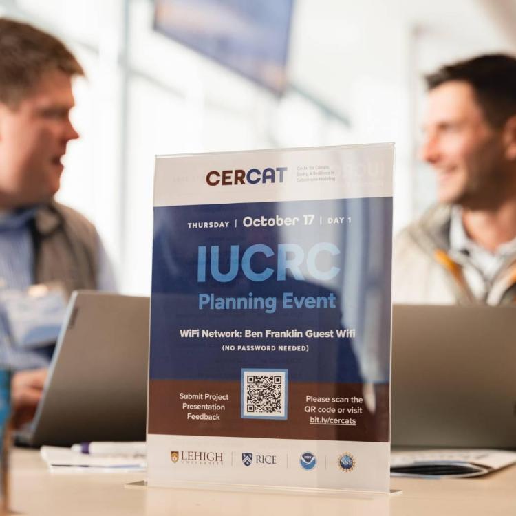 Two mean speaking in the background at a planning event