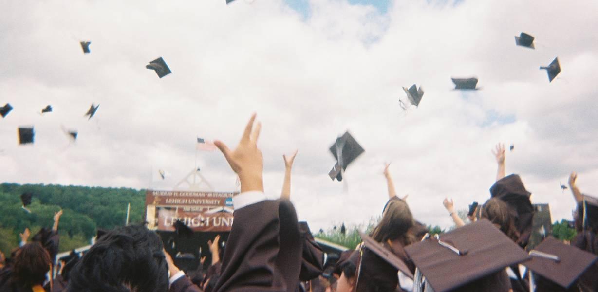Graduates throwing their caps in the air
