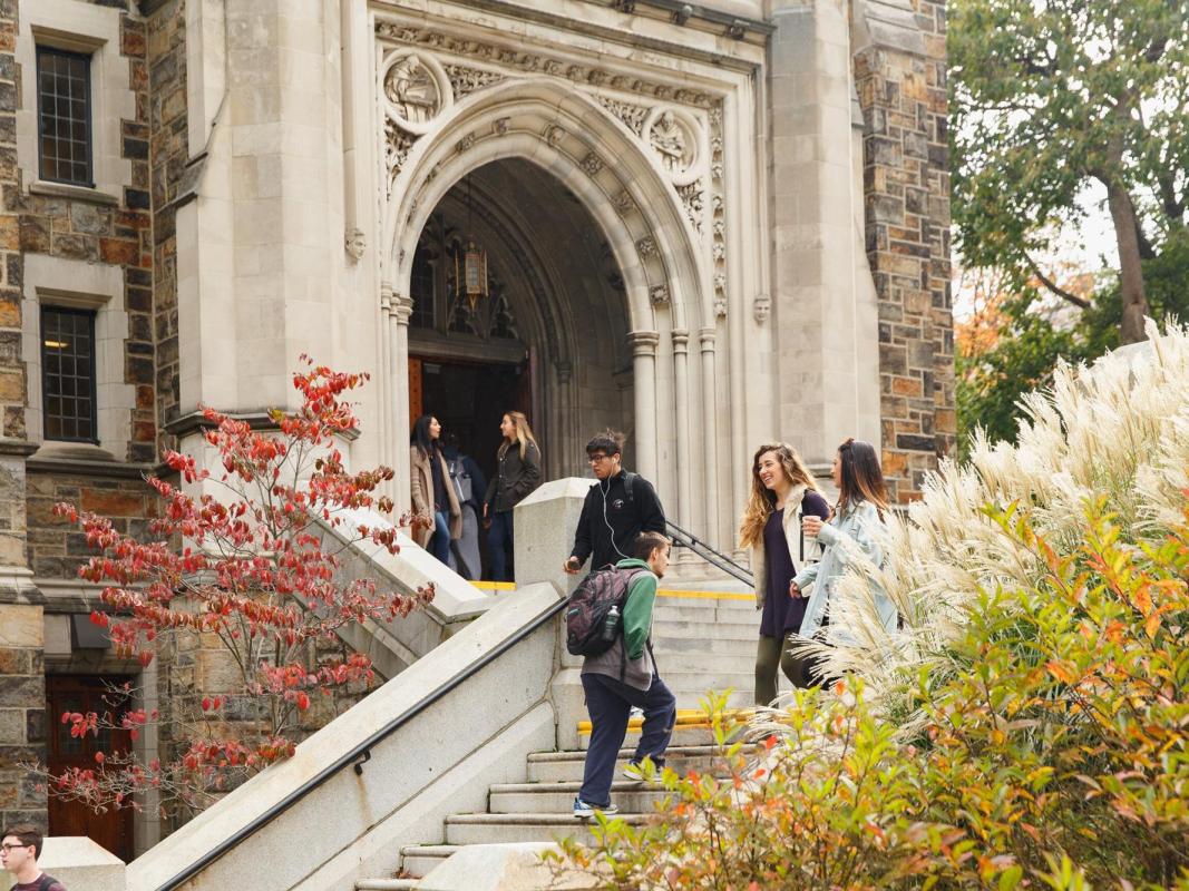 Students walking down a staircase from an academic building