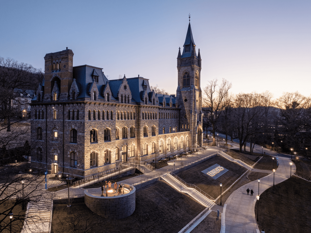 University Center at dusk, with warm lights glowing from its many windows.