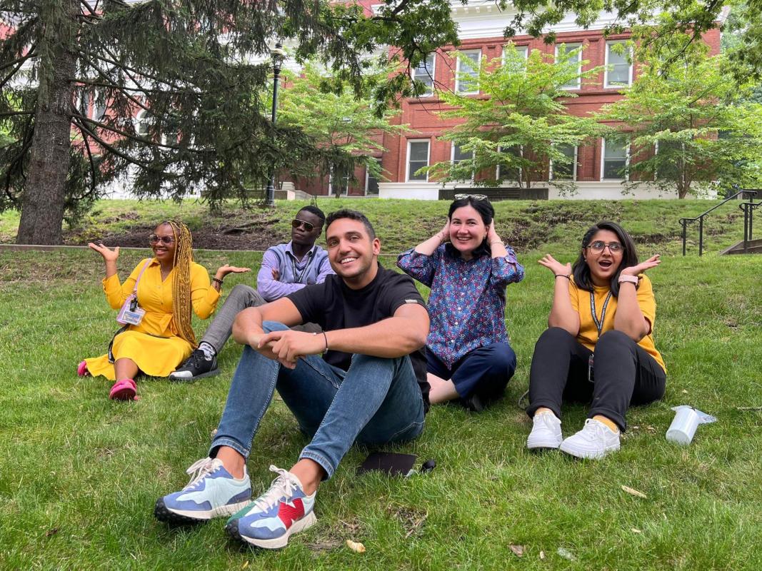 Students seated outside on the grass